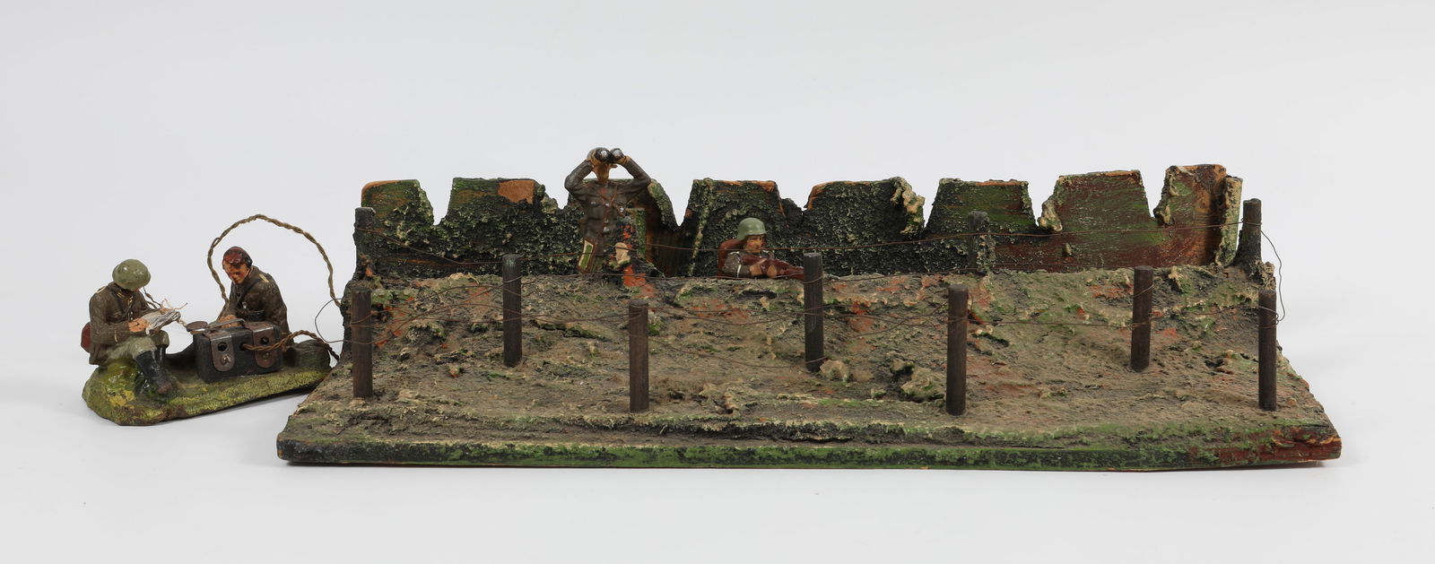 (4) PCS. ELASTOLIN SOLDIERS, MORSE CODE DUPLEX, TRENCH LANDSCAPE, ETC.: Includes: (1) two soldiers with wired morse code device, some wear and breaks, missing antenna; (1) solder with binoculars, some losses to back side of soldier; (1) kneeling soldier with rifle, losses