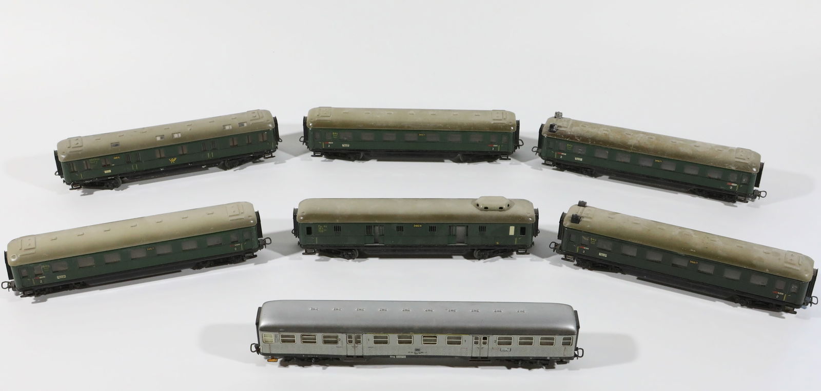 (7) MARKLIN TIN PASSENGER CARS: HO gauge, (4) 346/1 passenger cars, 1- roof detached but present; (1) 346/5, (1) 346/4 with sliding doors; (1) silver commuter car, all have age wear; light oxidation; longest 9 1/2", G-VG
