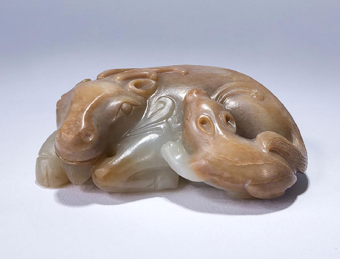 A WHITE JADE CARVING OF TWO BUFFALO (1 of 3)