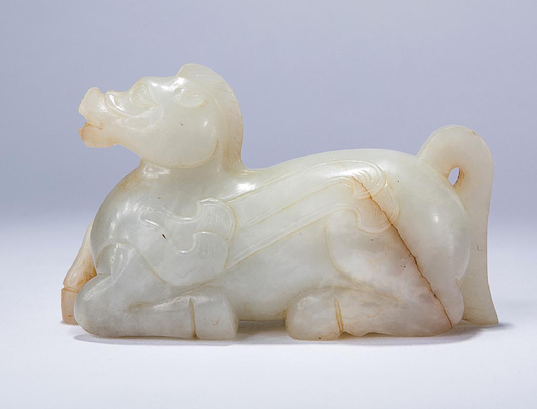 A WHITE JADE CARVING OF A MYTHICAL BEAST (1 of 2)