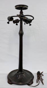 Attributed to Tiffany Studios Bronze Stick Base: Attributed to Tiffany Studios Bronze Stick Base. THe lamp base has cast bronze foot with simple hexagonal shaft leading to the 3-socket cluster. The base is finished in a brown patina with green highl