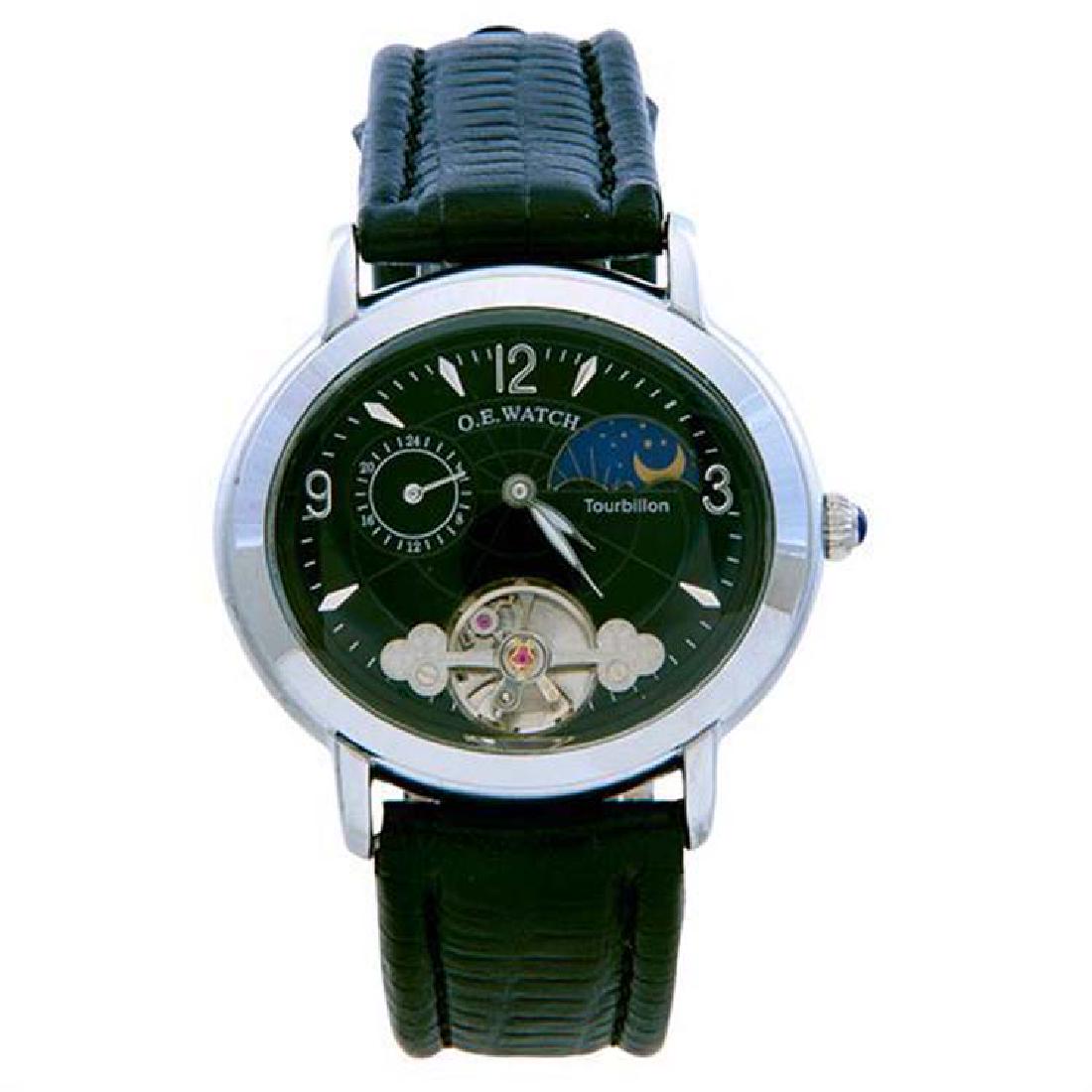 Erotic O.E. Watch Concealed Erotic Automated Wristwatch: Erotic O.E. Watch Concealed Erotic Automated Wristwatch Switzerland Tourbillion movement, moon phase dial and concealed scene oval face: 1 1/2 in. w. x 1 1/4 in. h. Condition Report: Arabic numbers, m