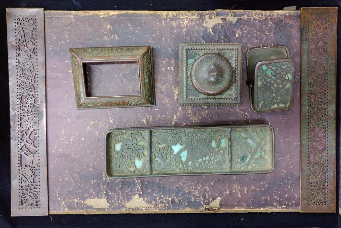 Five Tiffany Studios Art Glass and Bronze Desk Items: Five Tiffany Studios Art Glass and Bronze Desk Items New York, Circa 1912, all pieces in the grapevine pattern: Calendar frame no. 930 Inkwell no. 845, and a pen tray and paper clip (both with cracked