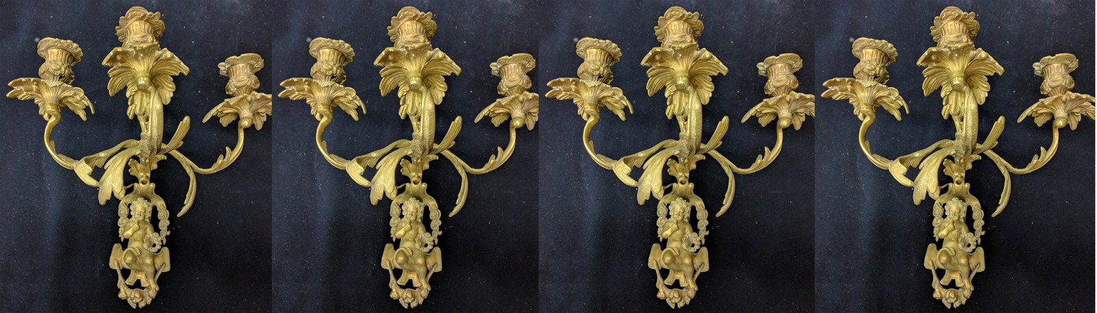Set of Four Wall Sconces Bronze 19th Century: Set of Four 19th Century French Rococo Style Bronze Wall Sconces Each three-light sconce with floral sockets, eagle finial, and putti base. Size: 16 in. H. If you would like to receive more detailed p