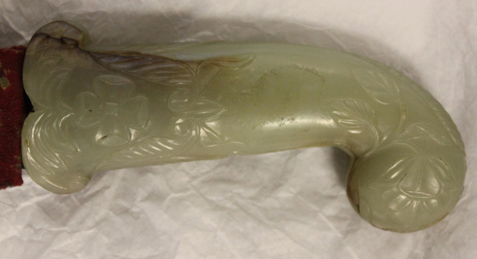 Mughal Dagger, 17th Century, Pistol-Shaped Jade: Mughal Dagger, 17th Century, Pistol-Shaped Jade Mughal Dagger, 18th century, pistol-shaped jade hilt carved with flowers, stone of celadon with brown fissures, steel blade. Size: Lg. 15 in. If you wou