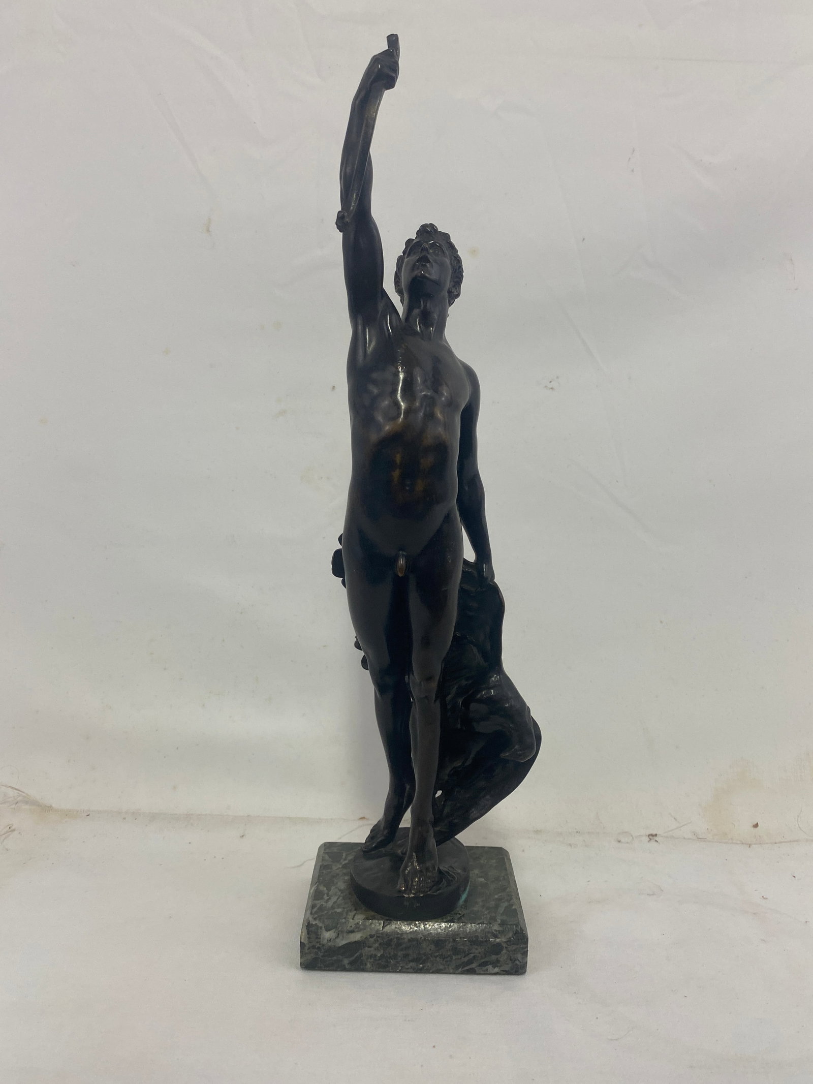 Bronze Sculpture by Joseph Uphues (German, 1850-1911: Bronze Sculpture by Joseph Uphues (German, 1850-1911) Cast by Akt.-Ges. Gladenbeck, Berlin A finely cast patinated bronze sculpture of a nude male figure with one arm raised, mounted on a green marble