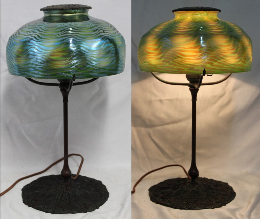 Tiffany Studios Favrile Glass Table Lamp with Wavy Green Shade: Tiffany Studios Favrile Glass Table Lamp with Wavy Green Shade An elegant early 20th century Tiffany Studios table lamp, featuring an iridescent Favrile glass shade decorated with undulating green wav