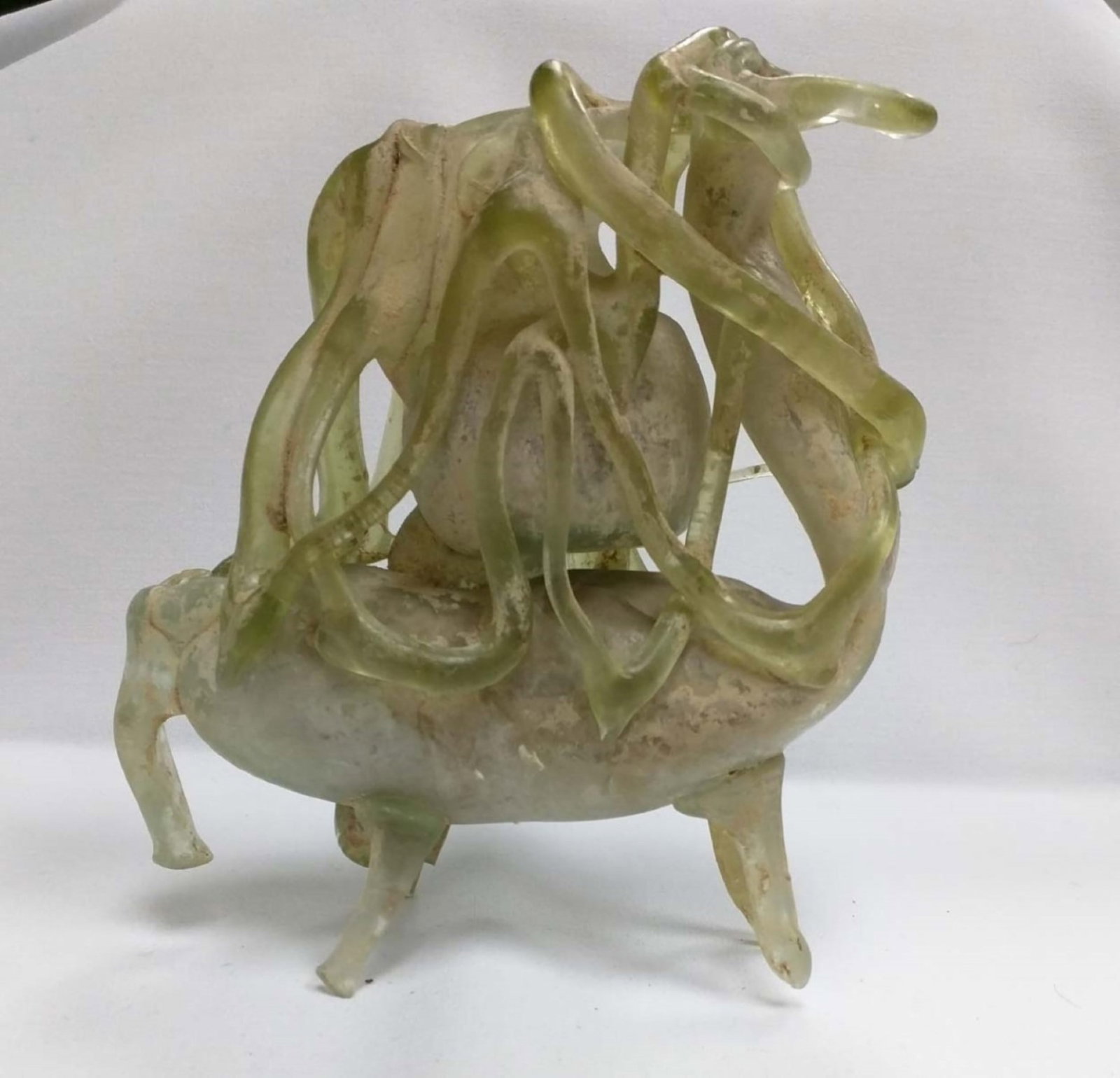 Ancient-Style Green Glass Serpent-Decorated Tripod Vessel / Ritual-Form Object: Ancient-Style Green Glass Serpent-Decorated Tripod Vessel / Ritual-Form Object Cast or mold-formed pale green glass vessel in an ancient-inspired tripod form, embellished with dramatic applied serpent