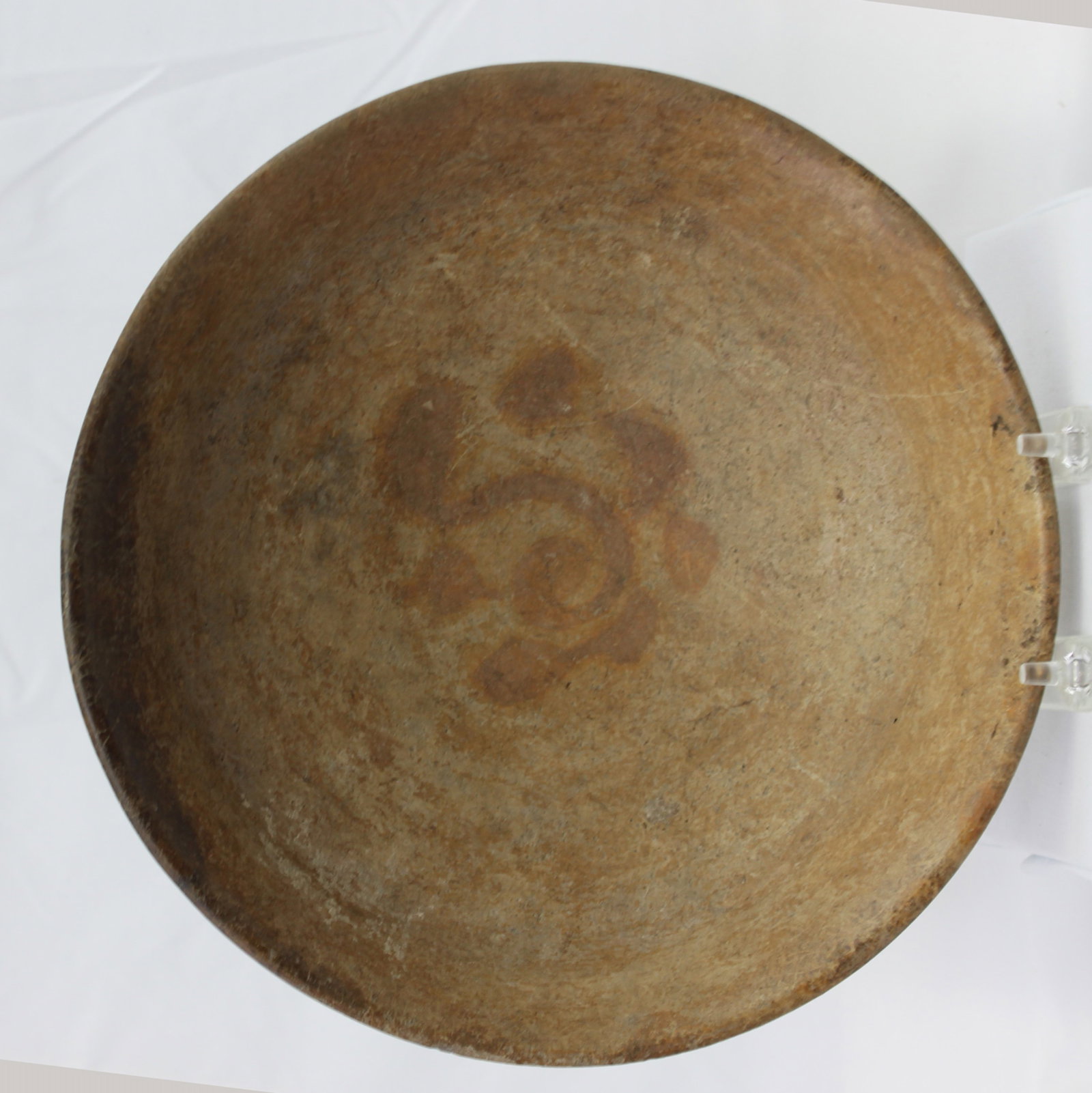 Ancient Near Eastern Earthenware Bowl with Central Rosette Motif: Ancient Near Eastern Earthenware Bowl with Central Rosette Motif Large hand-built ceramic bowl with a shallow, rounded profile and unglazed surface, centered by a faint iron-oxide rosette/flower medal