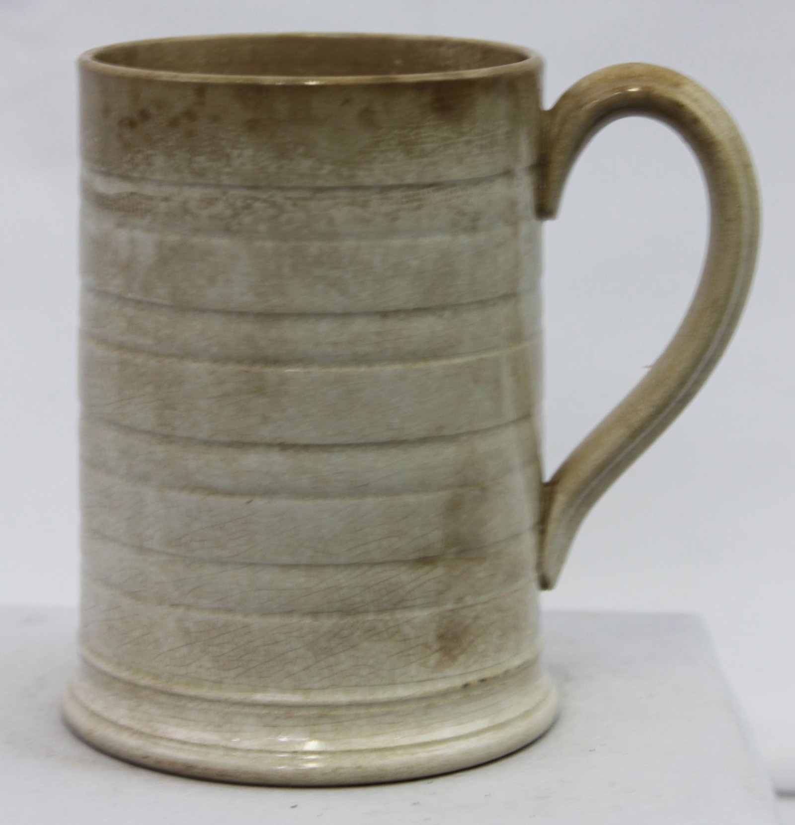 English Creamware Tankard / Mug, circa 1770-1800: English Creamware Tankard / Mug, circa 1770-1800 Georgian-period earthenware tankard with a warm cream glaze and subtle horizontal turning rings around the body. The plain cylindrical form with a pull