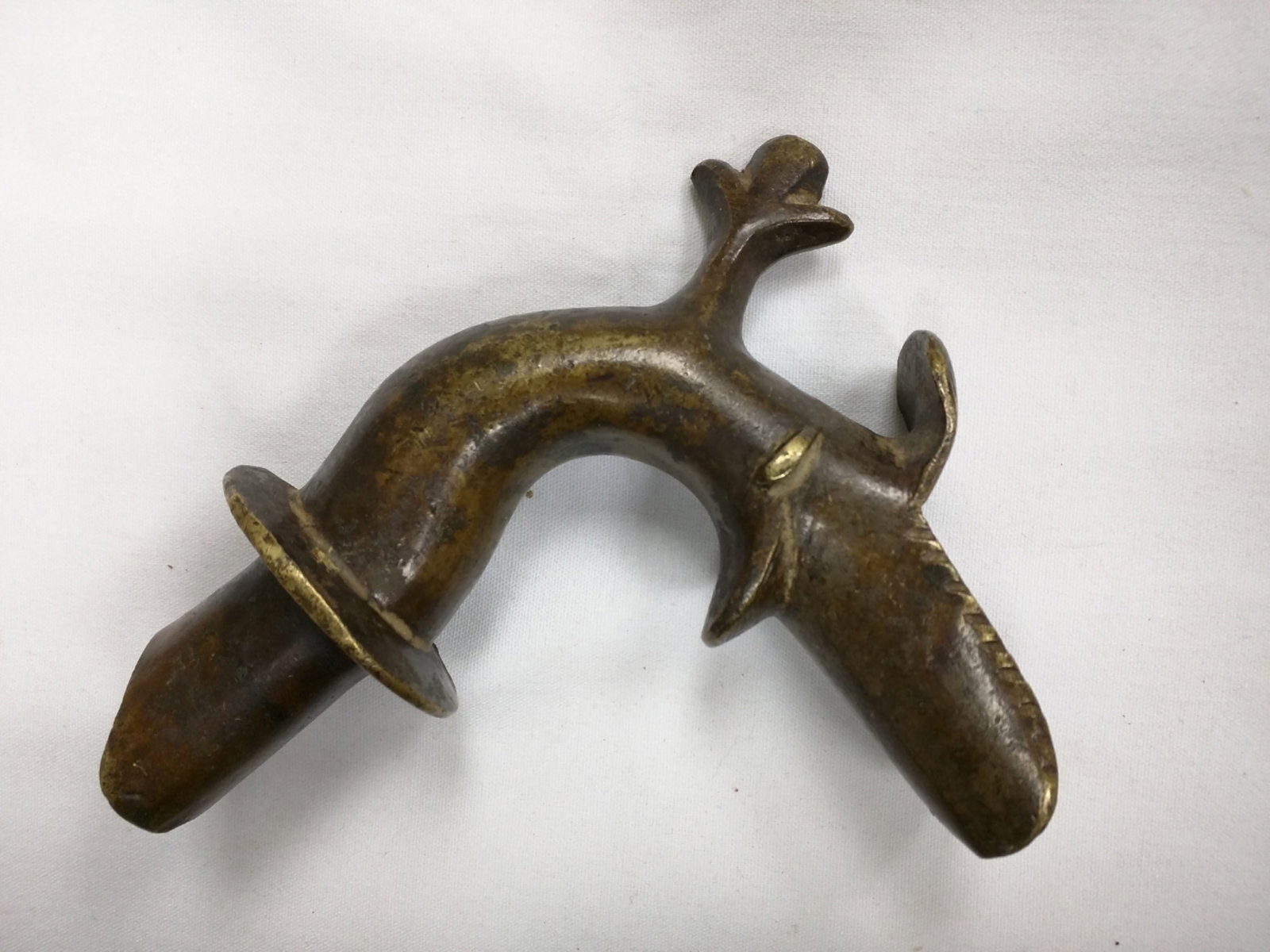 Circa 1280-1420 Medieval Bronze Zoomorphic Fountain Spout, Islamic Mediterranean: Medieval Bronze Zoomorphic Fountain Spout, Islamic Mediterranean, circa 1280-1420 Cast bronze architectural water spout of arched form with abstracted zoomorphic head terminating in an open mouth outl