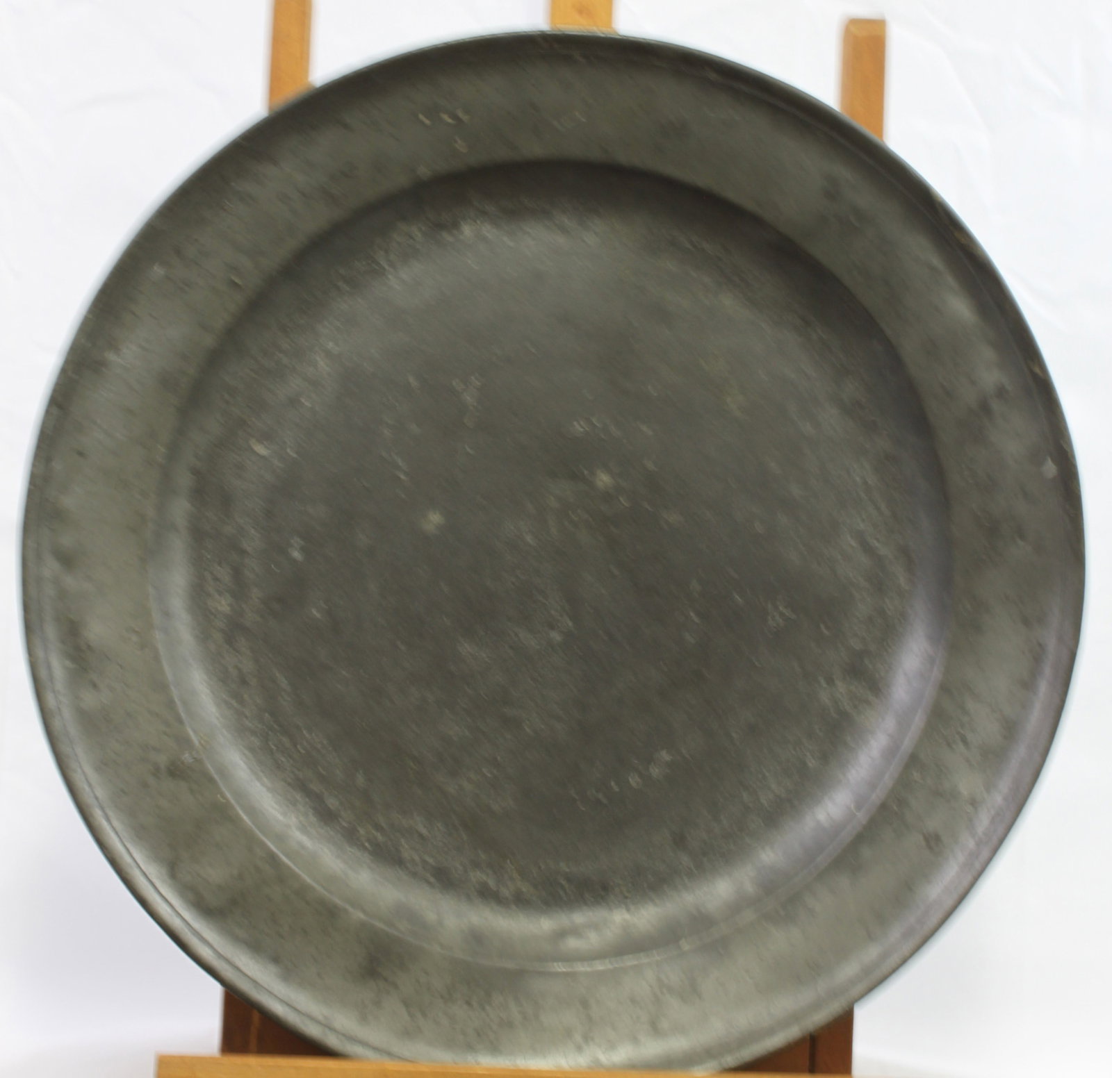 Circa 1680-1720 Antique Pewter Charger, English or Continental: Antique Pewter Charger, English or Continental, circa 1680-1720 Hand-raised pewter charger with broad cavetto and wide sloping rim, the surface showing characteristic gray patina, oxidation, and scatt