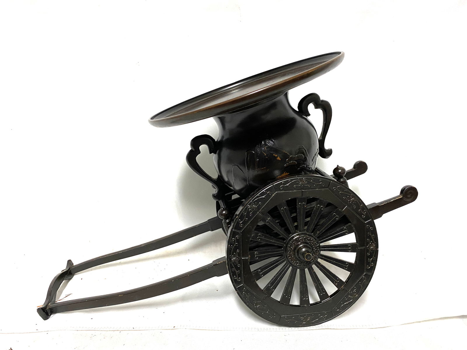 Japanese Metal Planter in the Form of a Handcart: Japanese Metal Planter in the Form of a Handcart Japanese metal planter modeled as a traditional handcart with spoked wheels and scrolling handles, the removable top section designed as a flaring-rim