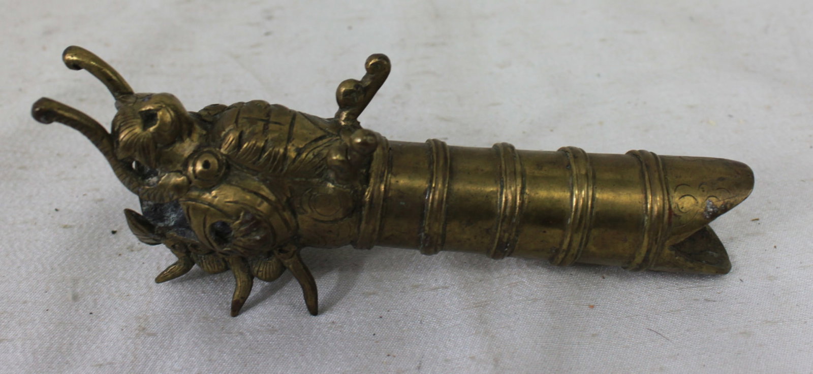 Chinese Bronze Dragon Head Spout Fitting: Chinese Bronze Dragon Head Spout Fitting A finely cast Chinese bronze spout in the form of a stylized dragon head, with curled horns, bulging eyes, and intricate decorative details. The open mouth and