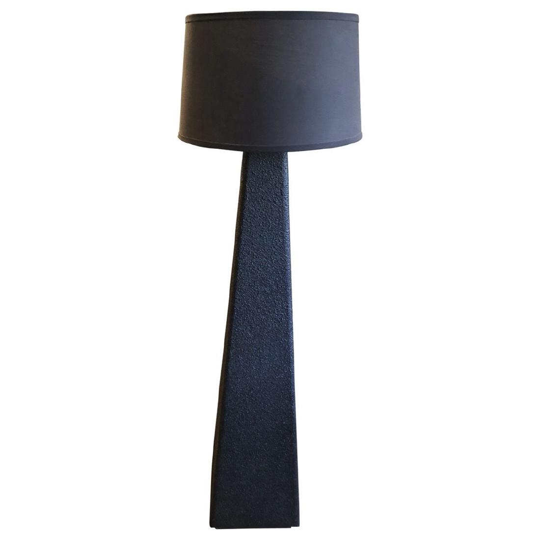 Textured Floor Lamp: Instantly upgrade your room with this striking lamp. This black textured lamp will add ambient lighting to any space. Comes with a brown cotton drum shade. MaterialsResin, Cotton Dimensions Width 11"