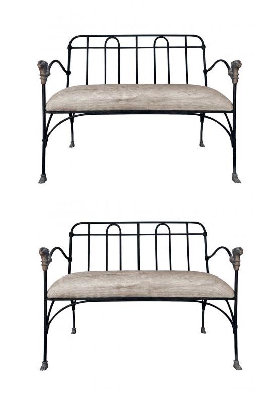 J-Art Iron Co Settees With Lion Heads: Two painted iron settees with upholstered seats. Bronze lion head accented finials at arms, and paw feet. MaterialsIron, Bronze, Fabric Dimensions Width 39" Depth 22" Height 33.50" Arm Height 26.50" S