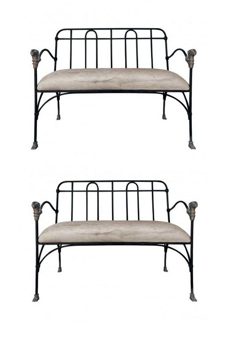 J-Art Iron Co Settees With Lion Heads: Two painted iron settees with upholstered seats. Bronze lion head accented finials at arms, and paw feet. MaterialsIron, Bronze, Fabric Dimensions Width 39" Depth 22" Height 33.50" Arm Height 26.50" S