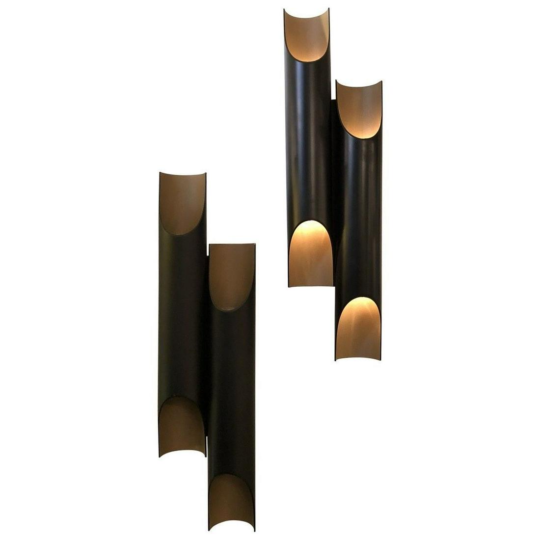Mid Century Black Tubular Sconces: Two powder-coated black tubular sonces with gold interior. Illuminates from top and bottom. MaterialsPowdercoated Metal Dimensions Width 5.25" Depth 4" Height 15.50"