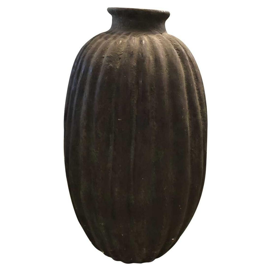 Ribbed Urn 21st Century: Contemporary style encompasses a range of concepts developed in the latter half of the 20th century. Pieces feature soft, rounded lines as opposed to the stark edges seen in modern design.MaterialsCer