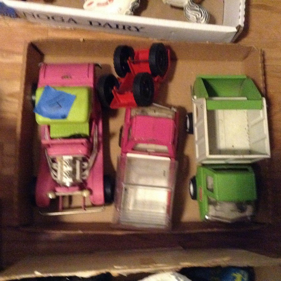 Box full of vintage tonka trucks: Box full of vintage tonka trucks: hot color pink