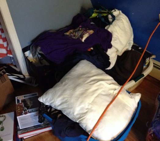 Large pile of clothing and totes: Large pile of clothing and totes