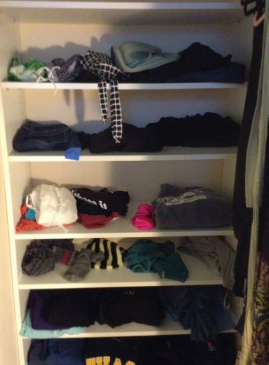 Inside contents of closet including jeans, sweatshirts,: Inside contents of closet including jeans, sweatshirts, swimsuit, shirts, shorts, woman's shoes and shoe stand