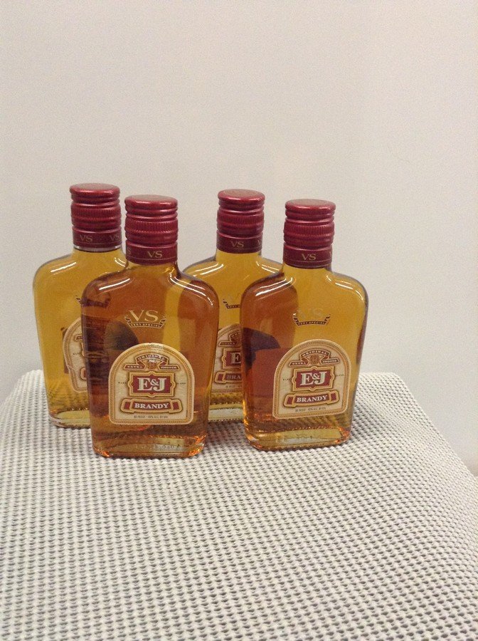 Lot of 4 E&J Brandy 200ML each: Any contents in bottle is Free; You are bidding on the bottle & unbroken tax stamp