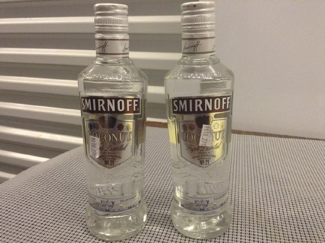 2 Bottles of Smirnoffs Coconut: Any contents in bottle is Free; You are bidding on the bottle & unbroken tax stamp