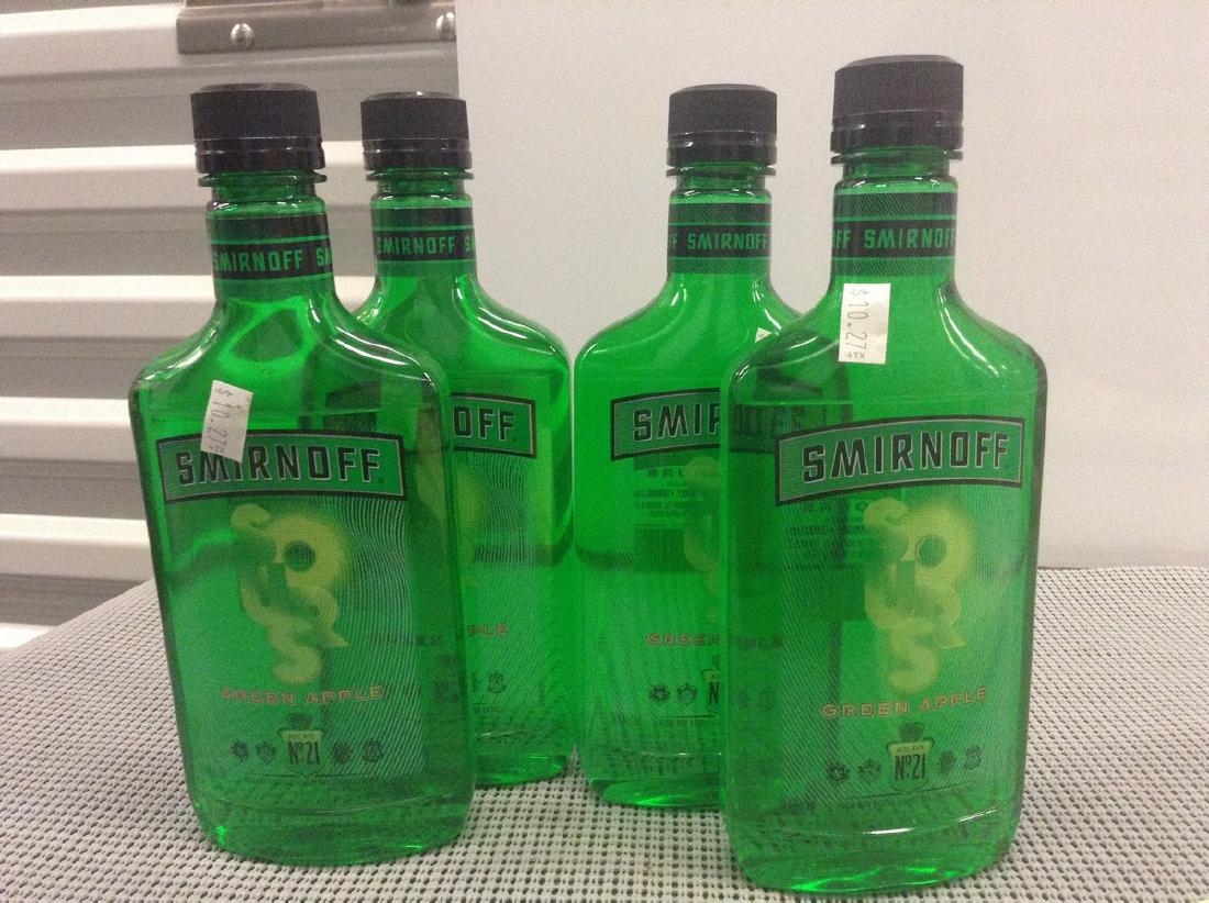 Lot of 4 Smirnoff Green Apple: Any contents in bottle is Free; You are bidding on the bottle & unbroken tax stamp