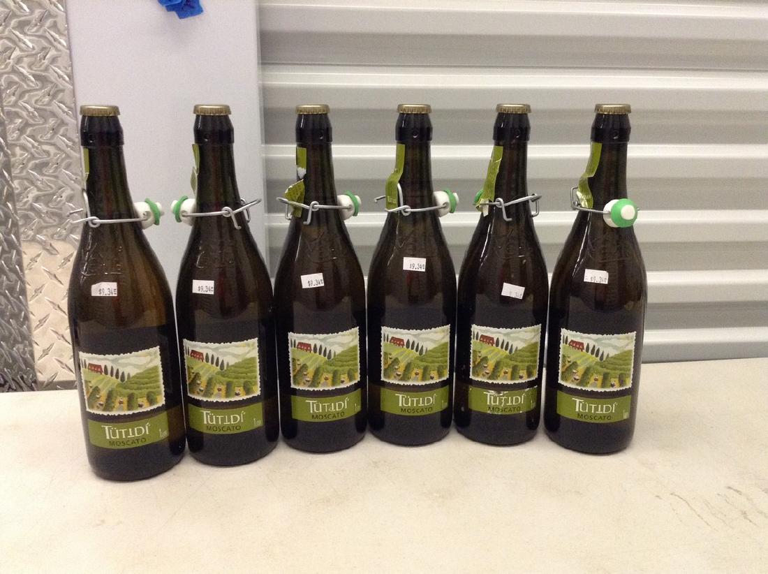 Lot of 6 bottles of tutid Moscato: Any contents in bottle is Free; You are bidding on the bottle & unbroken tax stamp