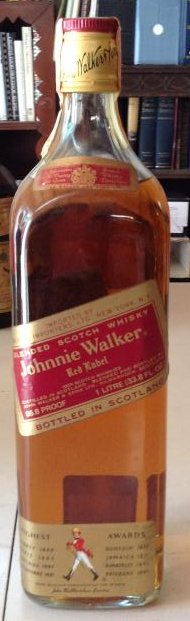 1960's Johnnie Walker Red Label Scotch Walker: Any contents in bottle is Free; You are bidding on the bottle & unbroken tax stamp