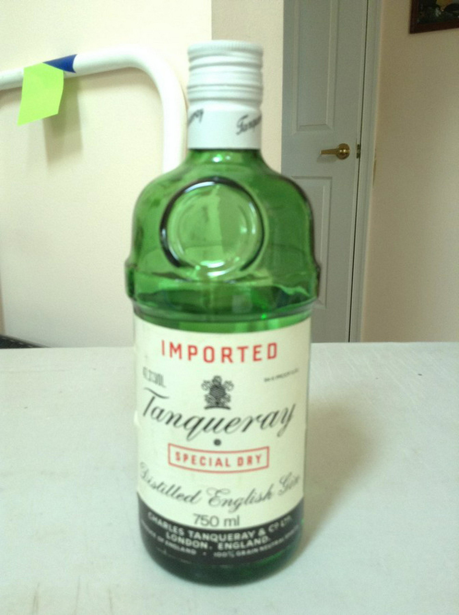 imported Tanqueray special dry distilled English gin: Any contents in bottle is Free; You are bidding on the bottle & unbroken tax stamp
