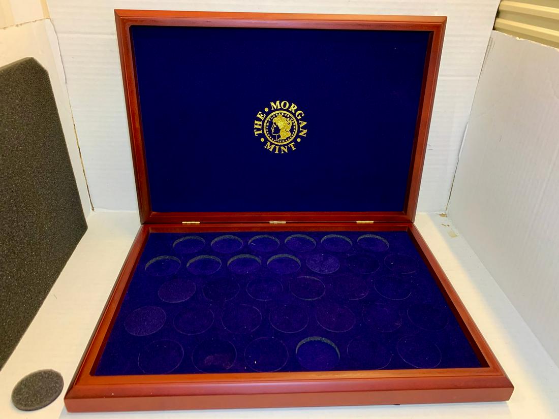 1 Morgan Mint Silver Dollardisploay box: good shape, lid attached.