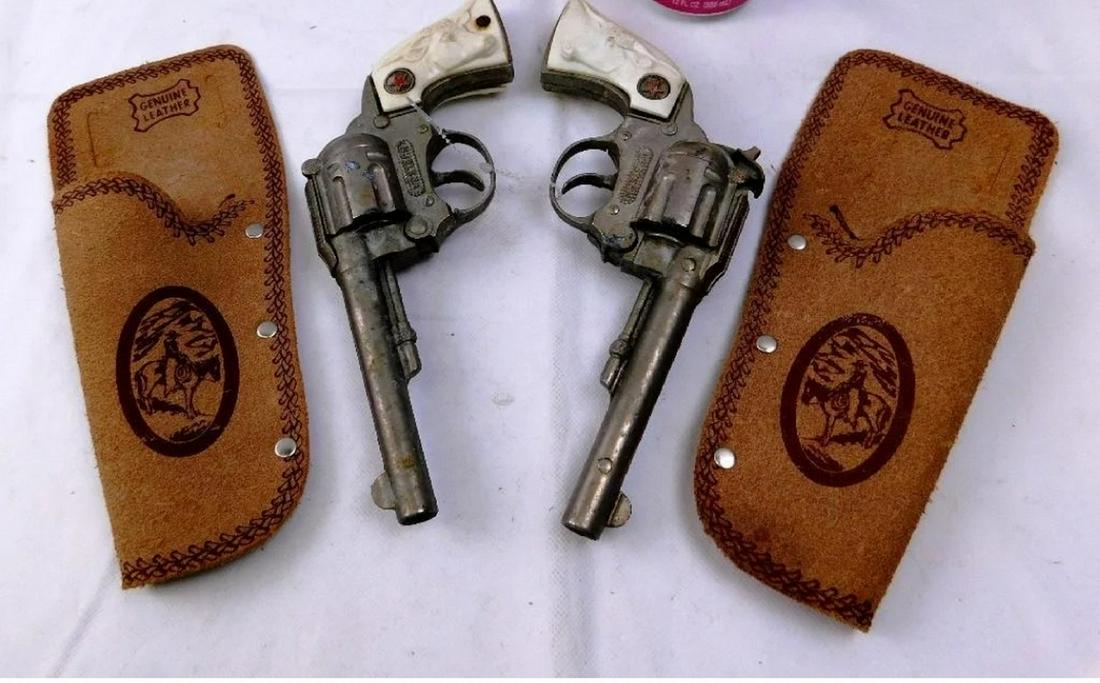 Pair of Western Cap pistols w/holsters: Pair of Western Cap pistols w/holsters - one missing clicker and one handle cracked