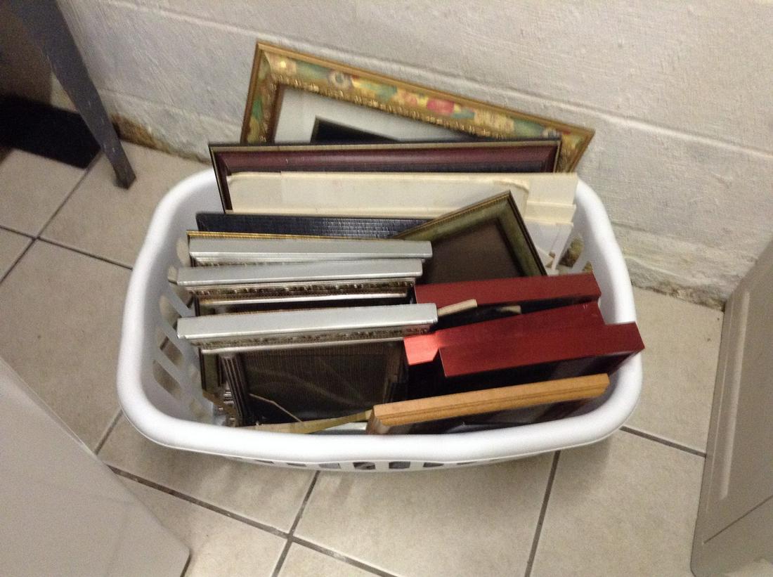 laundry basket full of picture frames: laundry basket full of picture frames