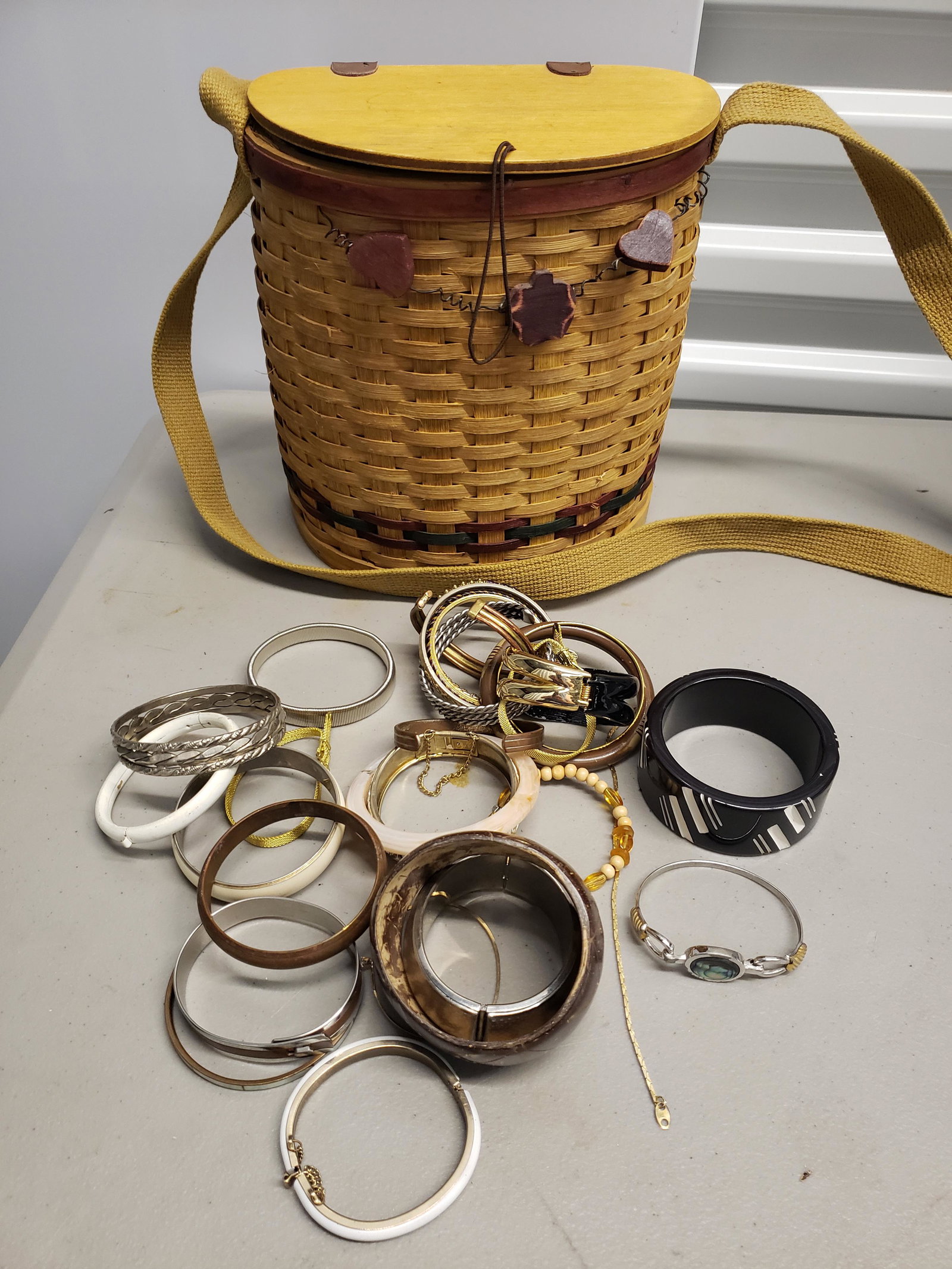 Lot of costume bracelets w/basket - possible some: Lot of costume bracelets w/basket - possible some bakelite did not test