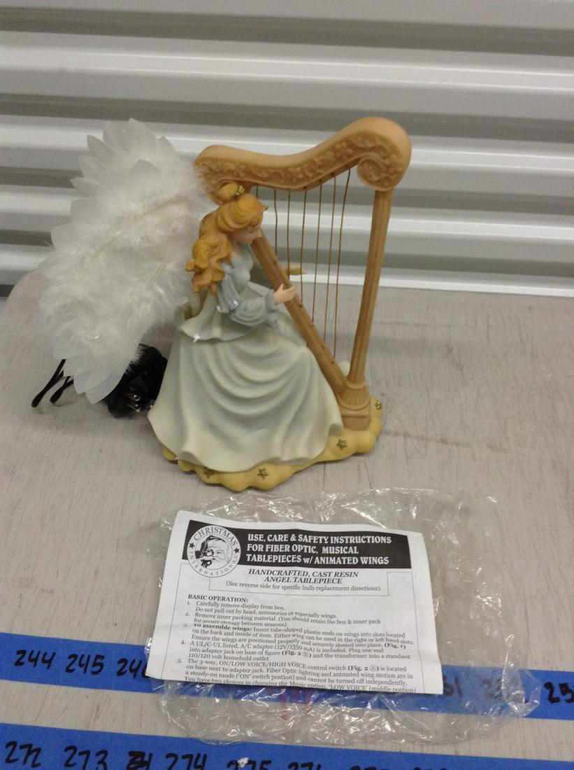 Christmas international statue of a lady playing harp: Christmas international statue of a lady playing harp