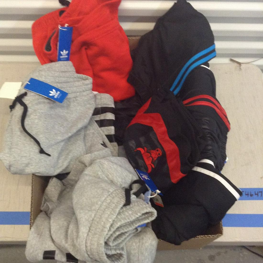 Box full of Adidas, Nike shorts and pants with tags: Box full of Adidas, Nike shorts and pants with tags