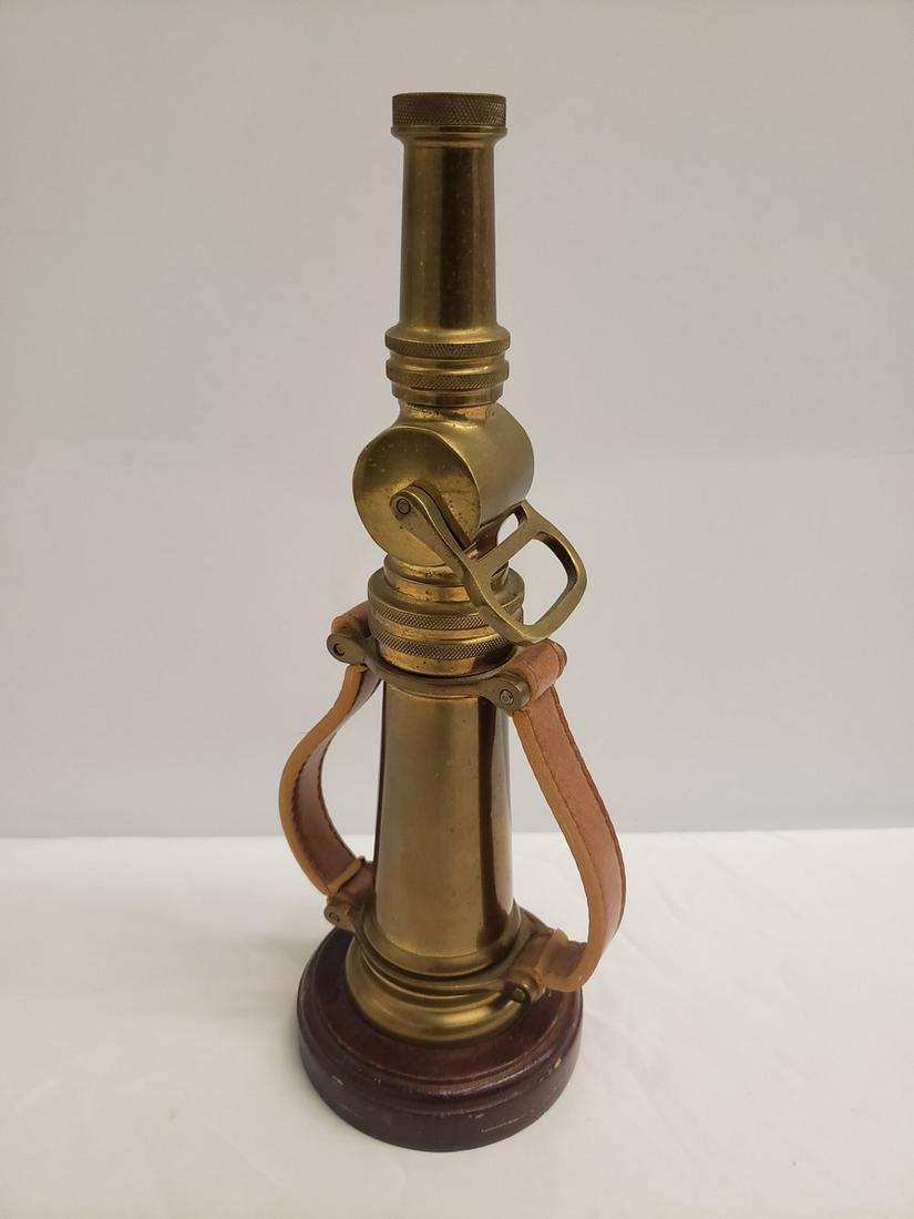 Vintage Brass fire hose on wood stand (1 of 1)