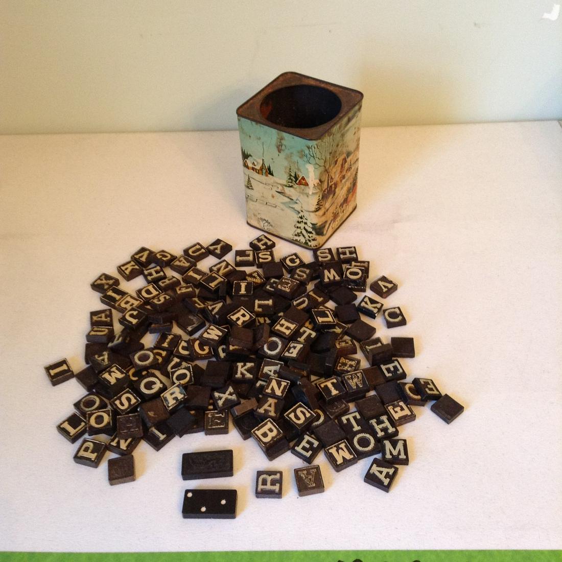 Tin full of old letter tiles: Tin full of old letter tiles