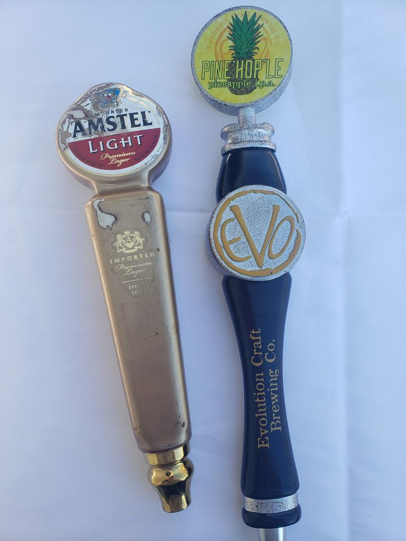 Two beer taps - Amstel light and Evolution Craft: Two beer taps - Amstel light and Evolution Craft