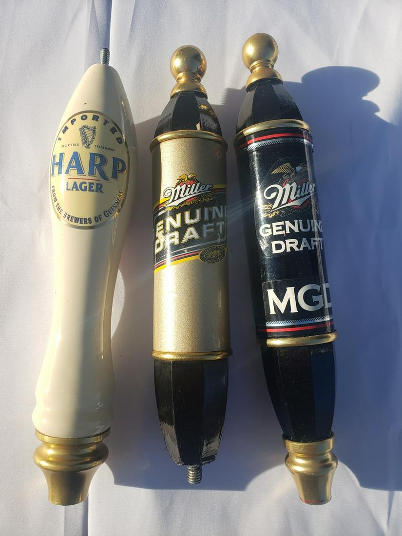 Three beer taps - two miller draft and one Harp lager: Three beer taps - two miller draft and one Harp lager