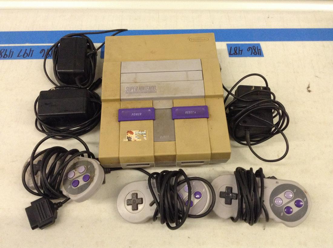 Super Nintendo console with controllers and adapter (1 of 1)