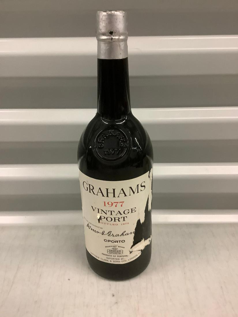 1977 Grahams Vinateg Port Filled Bottle: Any contents in bottle is Free; You are bidding on the bottle & unbroken tax stamp