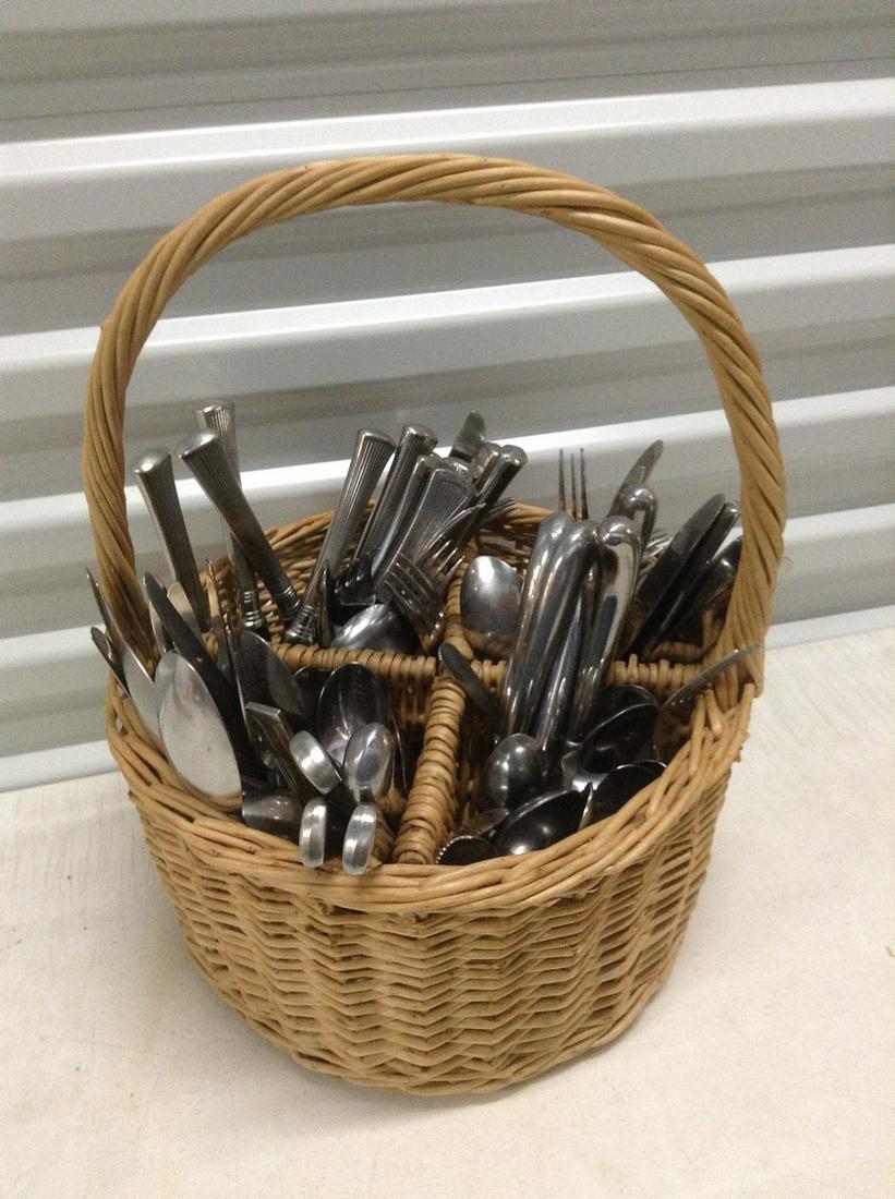 Large basket full of flatware: Large basket full of flatware