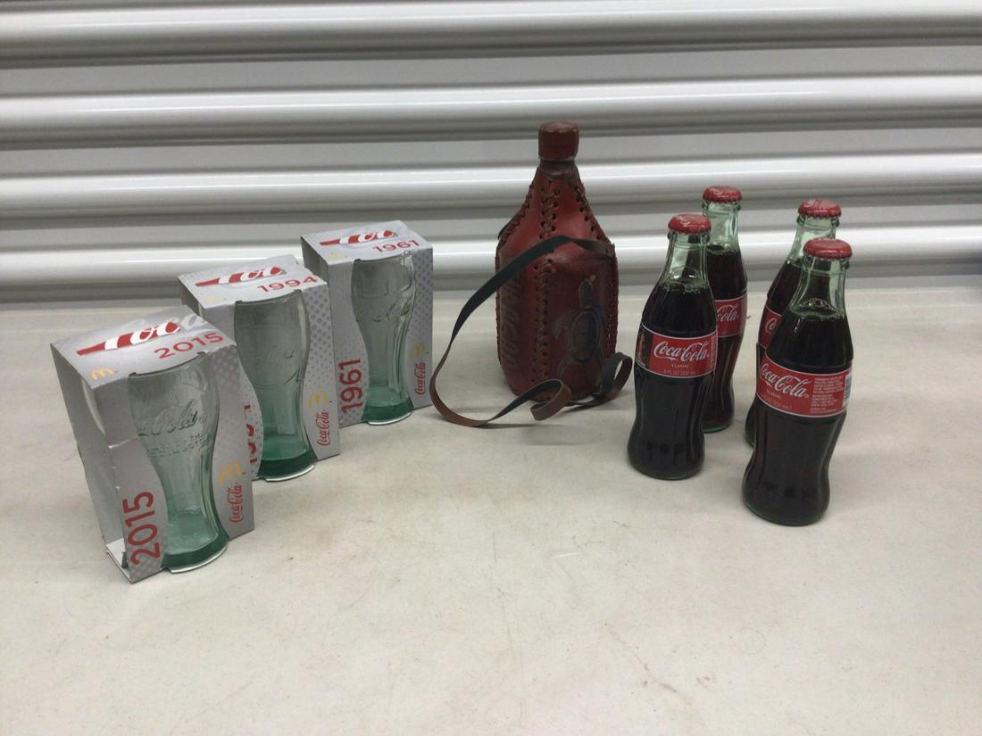 Lot of Coca Cola glasses, Coca Cola bottles, and Curacao water bottle: Lot of Coca Cola glasses, Coca Cola bottles, and Curacao water bottle