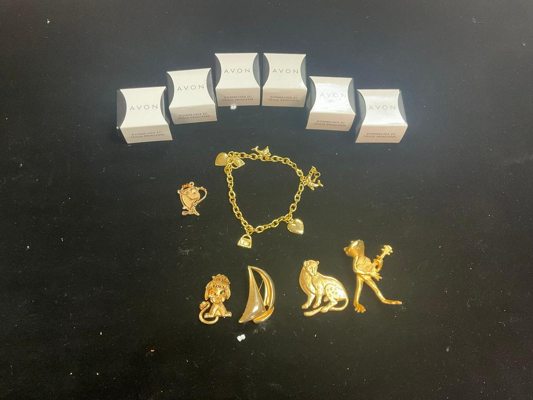Lot of six Avon CZ studs, gold charm bracelet, Tazmanian Devil charm, and four gold brooches: Lot of six Avon CZ studs, gold charm bracelet, Tazmanian Devil charm, and four gold brooches