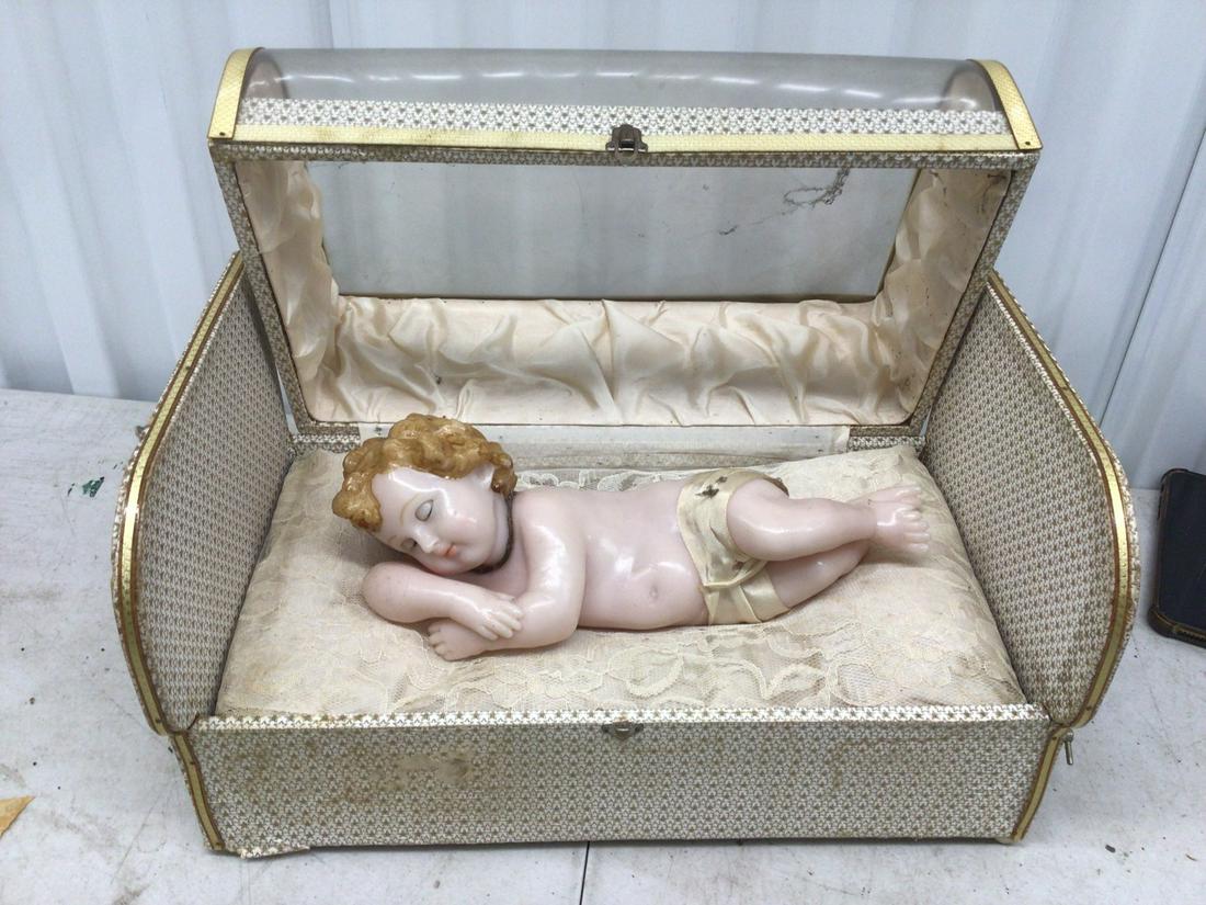 Infant statuette in silk lined box with winch: 14"