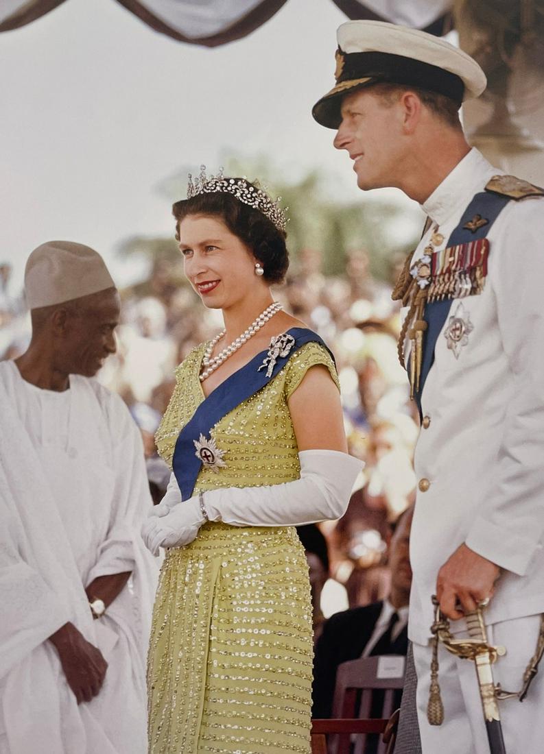 Queen Elizabeth II - Her Majesty at the Gala Event: QUEEN ELIZABETH II (1926-2022) Her Majesty and her Husband are seen at a Gala Event in Serra Leone, 1961 Print in Colors 9 1/2" x 13 1/2" Elizabeth II, in full Elizabeth Alexandra Mary, officially Eli