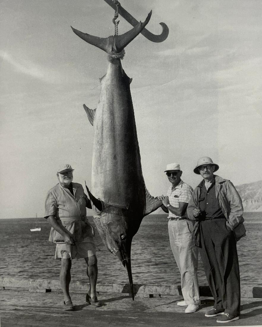Ernest Hemingway - Hemingway with Marlin, 1956: ERNEST HEMINGWAY (1899-1961) Hemingway with top Cuban fisherman Elicio Arguelles and outdoorsman Ellis Briggs, 1956 Print in Colors 6 1/2" x 8" Ernest Hemingway, in full Ernest Miller Hemingway, (born